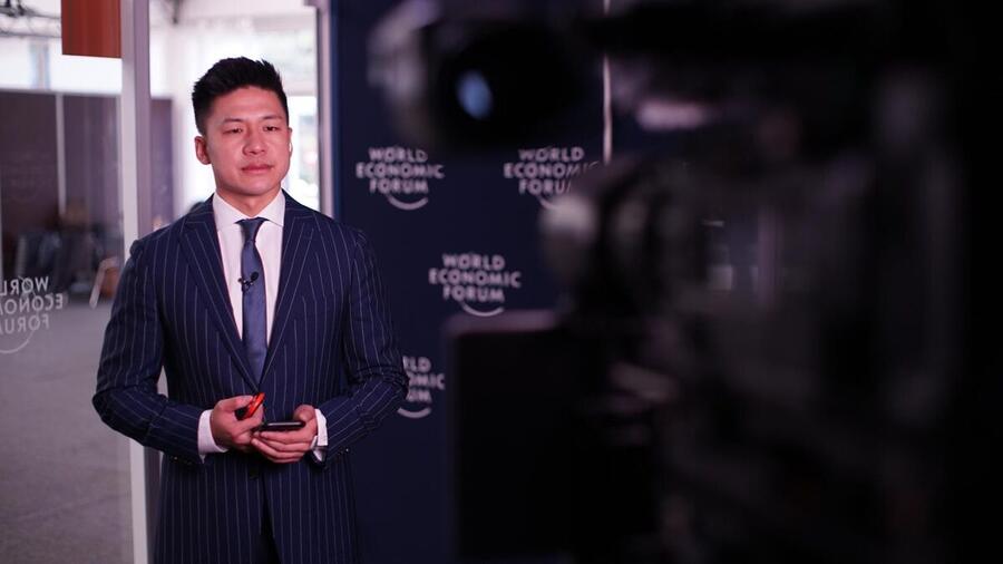 Bin Chen preparing to record a piece to camera at the World Economic Forum